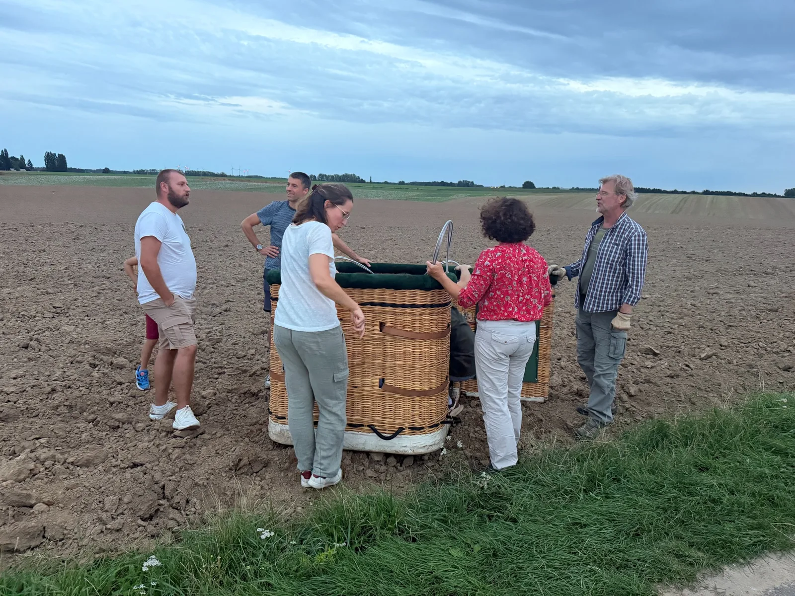 Crew members around a hot air balloon basket